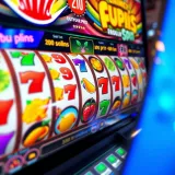 Colorful online pokies reels with various fruit and casino symbols spinning on a digital screen